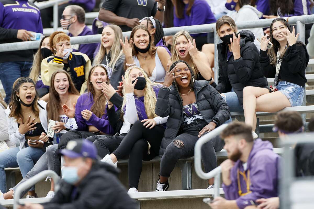 SEATTLE, WASHINGTON - MAY 01: Fans cheer toward a television camera during the first half of the spring game at Husky Stadium on May 01, 2021 in Seattle, Washington. (Photo by Steph Chambers/Getty Images)