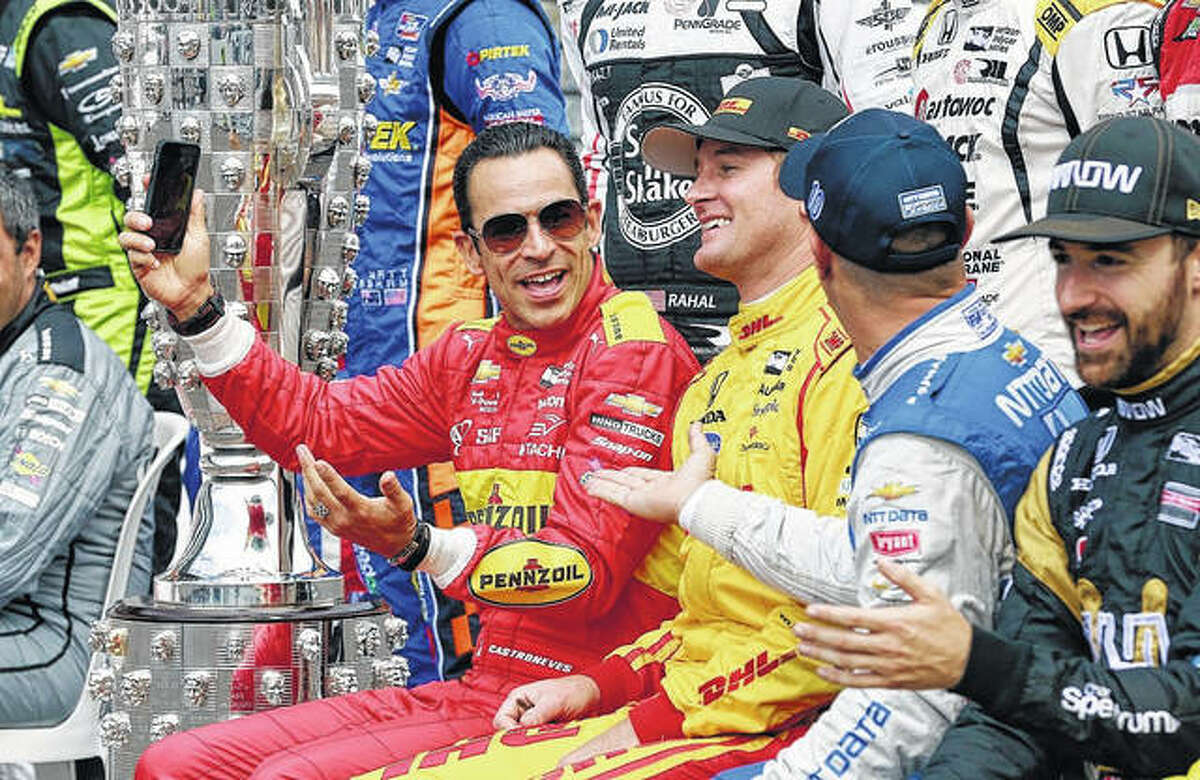 Ryan Hunter-Reay, center, and Tony Kanaan, right, joke with Helio Castroneves, left, before the final practice session for the 2016 Indianapolis 500. Hunter-Reay and Kanaan are two of the seven former Indy 500 champs who will race in this year’s Bommarito 500 at Worldwide Technology Raceway in Madison.