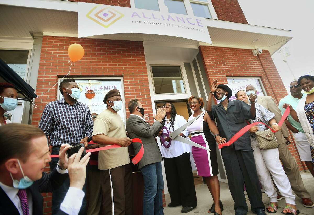 Executive Director Monette Ferguson cuts the ribbon on a new neighborhood office of Alliance for Community Empowerment, formerly ABCD, at 1376 Stratford Avenue in Bridgeport, Conn. on Wednesday, August 11, 2021.