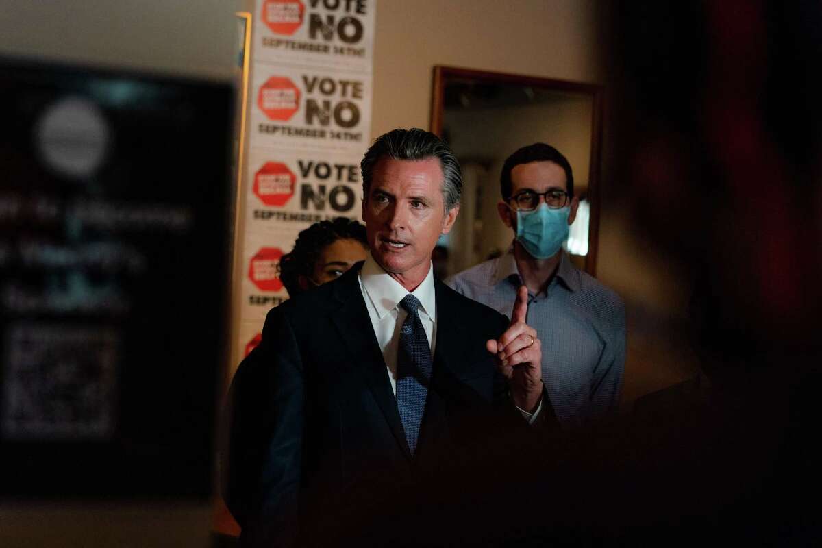 Gov. Gavin Newsom speaks to reporters during a press conference for his “Vote No” camapaign at Manny’s in San Francisco.