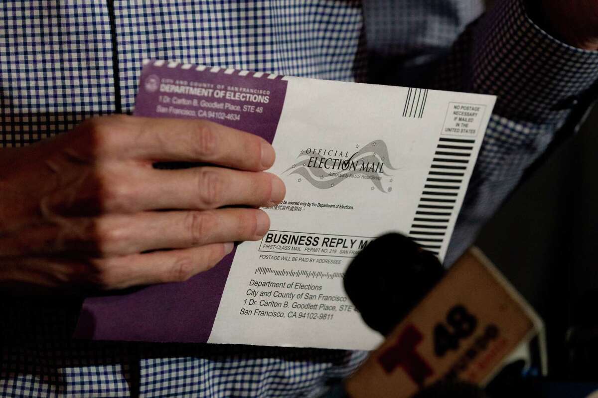 An envelope holding a voting ballot for the upcoming gubernatorial recall election is seen in the hands of State Senator Scott Wiener at Manny’s in San Francisco, Calif., on Friday, August 13, 2021.