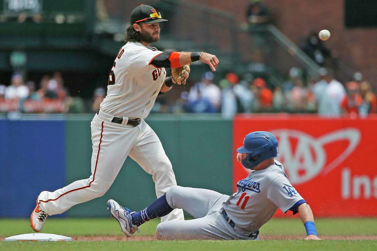 San Francisco Giants shortstop Brandon Crawford forces out Los Angeles Dodgers A.J. Pollock (11) and throws to first for the double play in the fifth inning at Oracle Park on July 29, 2021, in San Francisco.