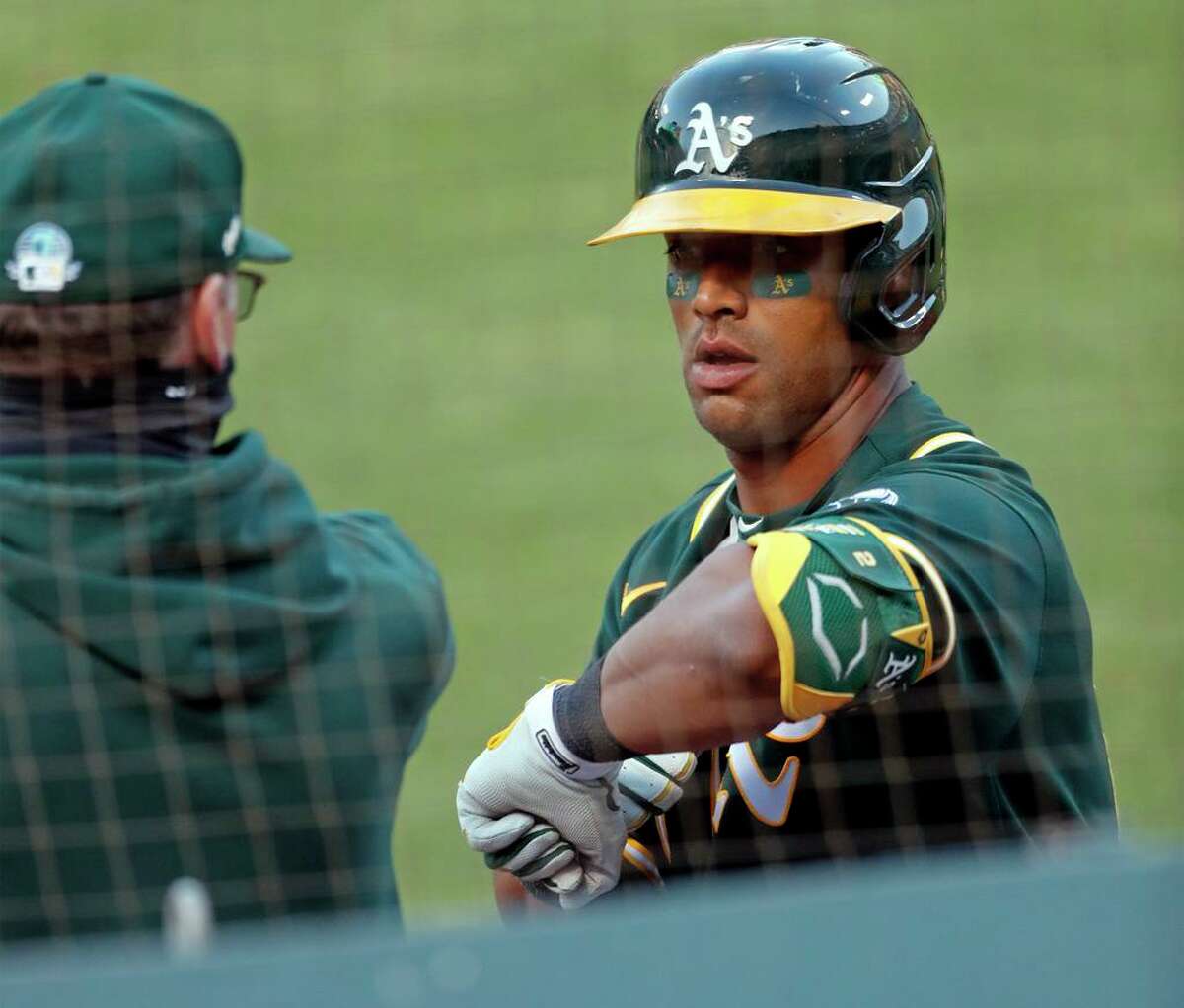 Oakland Athletics' Khris Davis returns to dugout after hitting RBI sacrifice fly in 4th inning against San Francisco Giants during exhibition game at Oakland Coliseum in Oakland, Calif., on Monday, July 20, 2020.