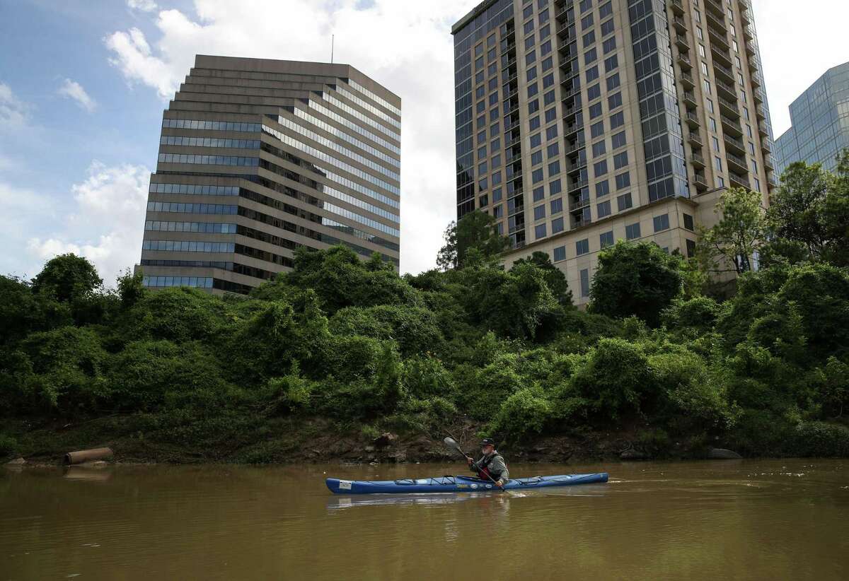 Bruce Bodson kayaks Sunday, Aug. 8, 2021, in Buffalo Bayou in Houston.