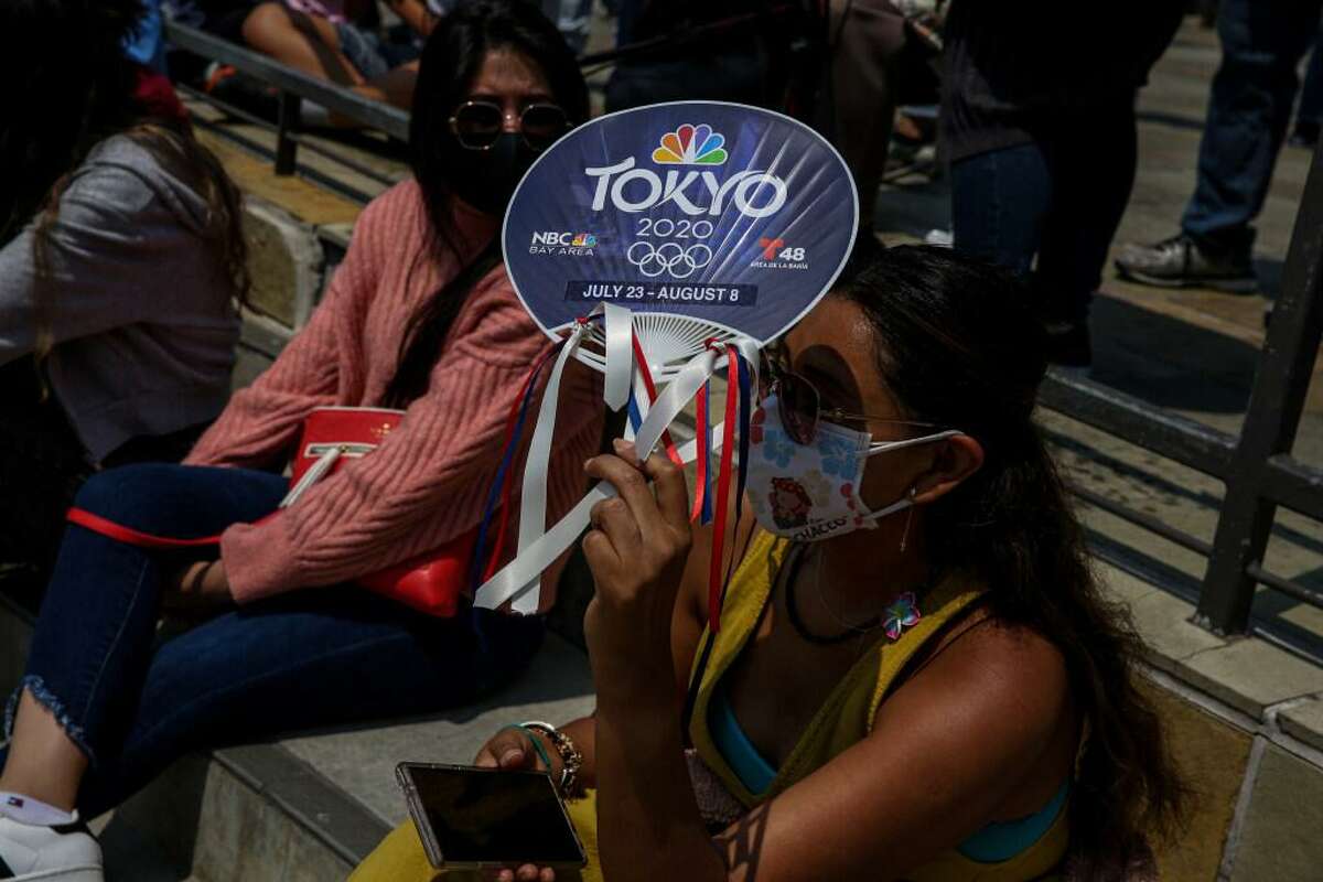 Fans shade participants watching traditional dancers during the annual Nihonmachi Street Fair in San Francisco, Calif. on Sunday, Aug. 8, 2021.
