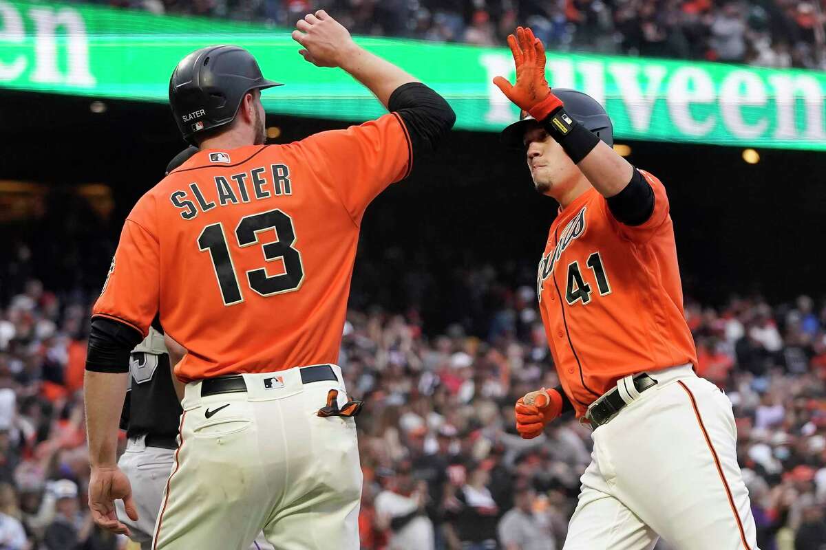 San Francisco Giants' Wilmer Flores (41) celebrates after hitting a three-run home run that also scored Austin Slater (13) during the first inning of after a baseball game in San Francisco, Friday, Aug. 13, 2021. (AP Photo/Jeff Chiu)