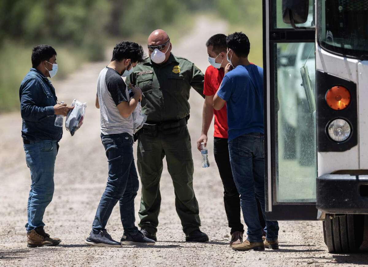 A U.S. Border Patrol agent instructs unaccompanied teenagers in La Joya before they’re sent to a facility.