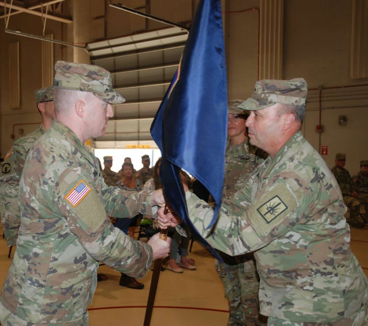 Maj. Doug Berinstein, left, accepts the  unit  flag of the Joint Force Headquarters Detachment from Maj. Gen. Michel Natali, assistant adjutant of the New York Army National Guard.(Major Jean-Marie Kratzer / New York Army National Guard)