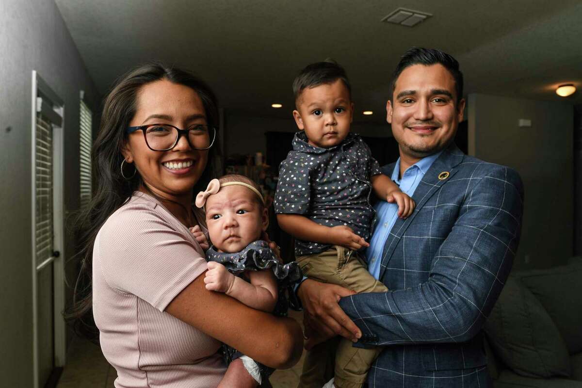 Oscar Salinas, right, a Bexar County assistant district attorney, helped his wife, Yasmin, left, give birth to baby Camila in their living room on July 13. Their 2-year-old son, Giovanni, helped coach his mother.
