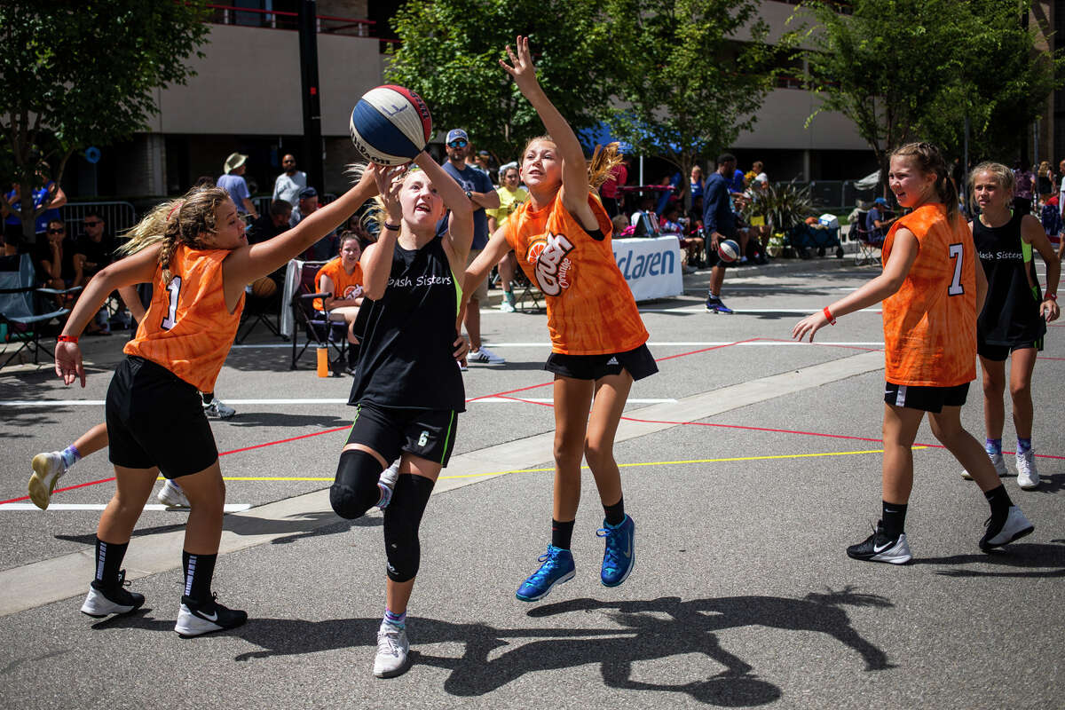 Bria Hogeboom of Grand Haven, 12, takes a shot as hundreds of athletes compete in the Gus Macker 3 on 3 basketball tournament Saturday, Aug. 14, 2021 in downtown Midland. (Katy Kildee/kkildee@mdn.net)