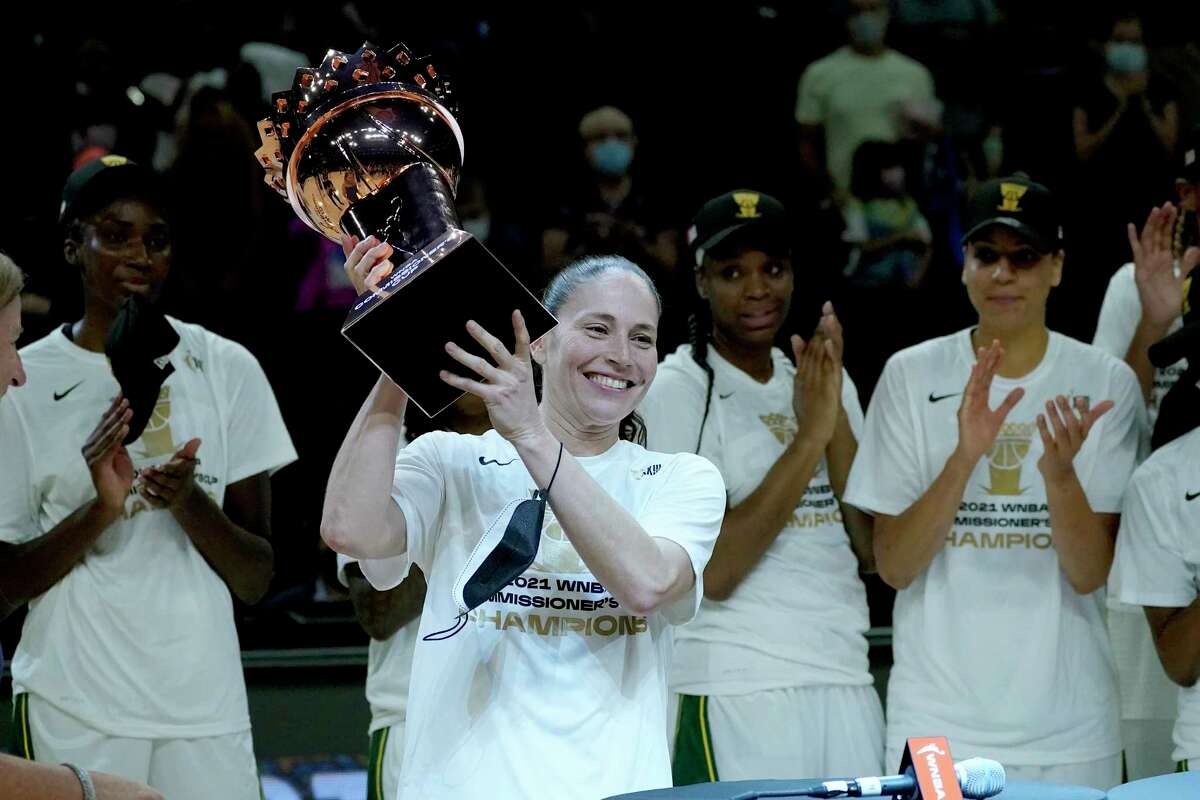 Seattle Storm guard Sue Bird holds the champions trophy after the Commissioner's Cup WNBA basketball game against the Connecticut Sun, Thursday, Aug. 12, 2021, in Phoenix. (AP Photo/Matt York)