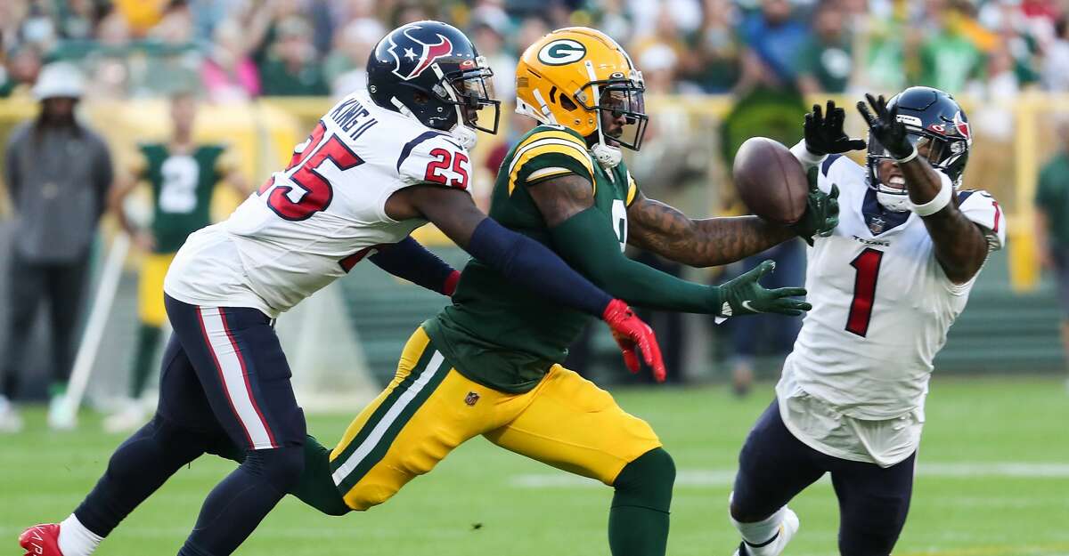 Houston Texans defensive back Desmond King II (25) and cornerback Lonnie Johnson (1) break up a pass intended for Green Bay Packers wide receiver Amari Rodgers (8) during the first quarter of an NFL pre-season football game Saturday, Aug. 14, 2021, in Green Bay, Wis.