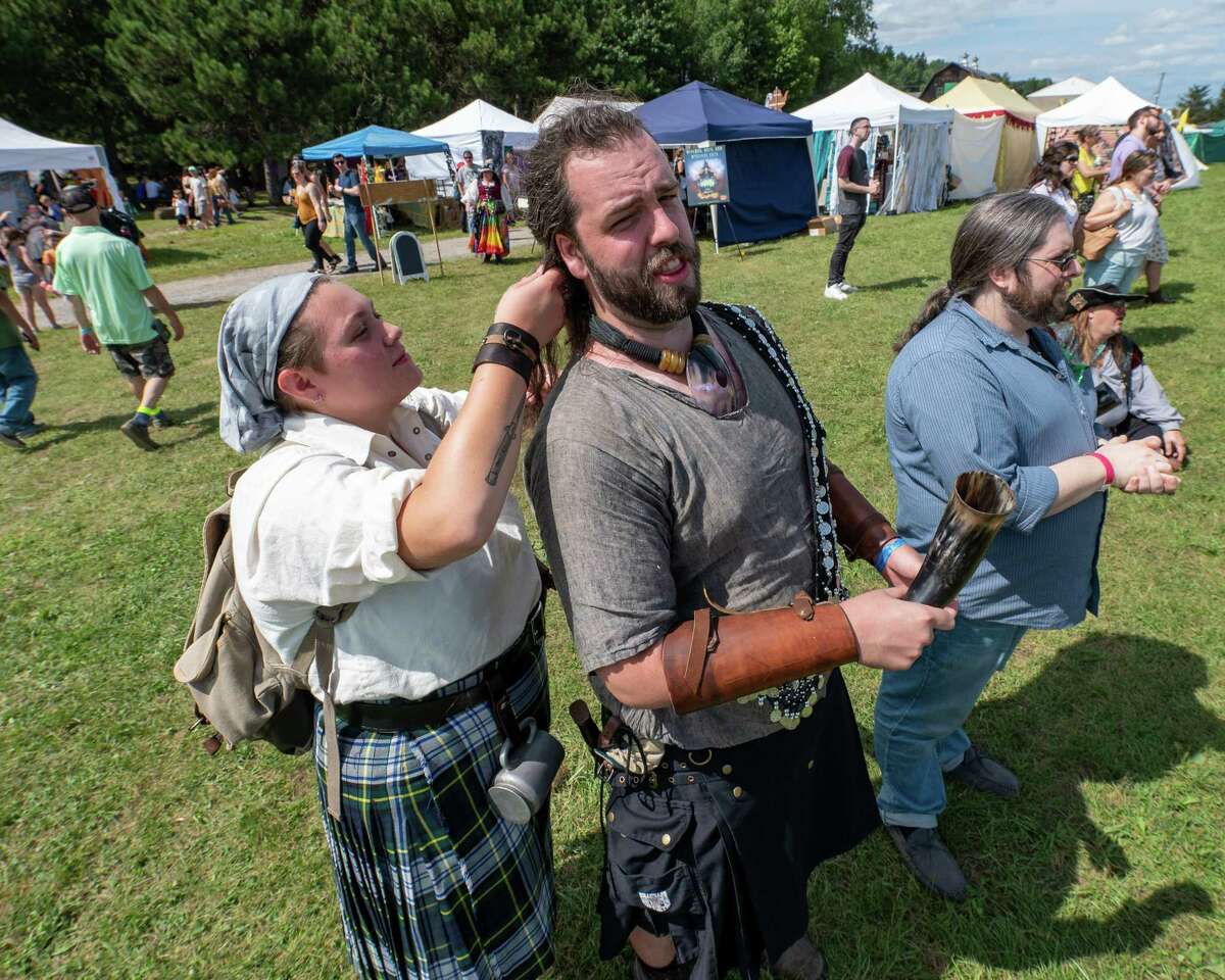 Ava Grande braids the hair of Japhid Moses during the Renaissance Festival at Indian Ladder Farms Apple Orchard in Altamont, NY, on Sunday, Aug. 15, 2021 (Jim Franco/Special to the Times Union)