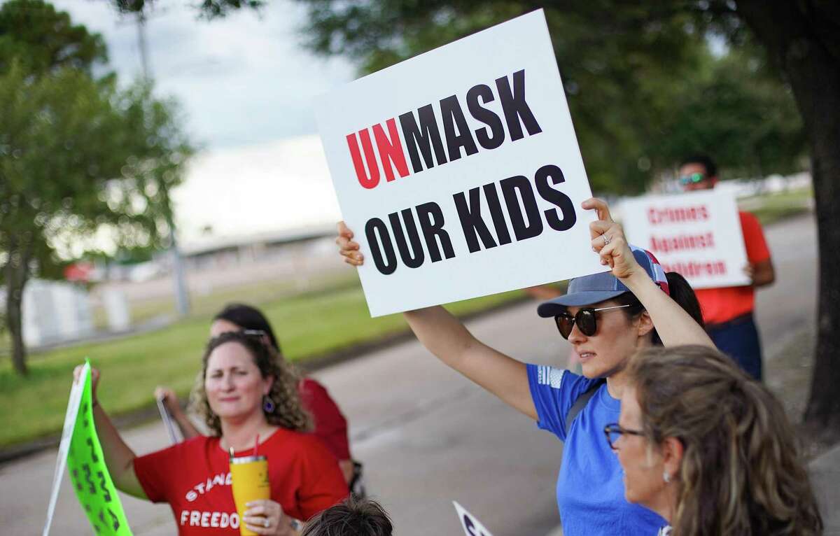 Anti-mask demonstrators outside Houston Independent School District building before it holds a meeting about having a mask mandate in Houston on Thursday, Aug. 12, 2021.