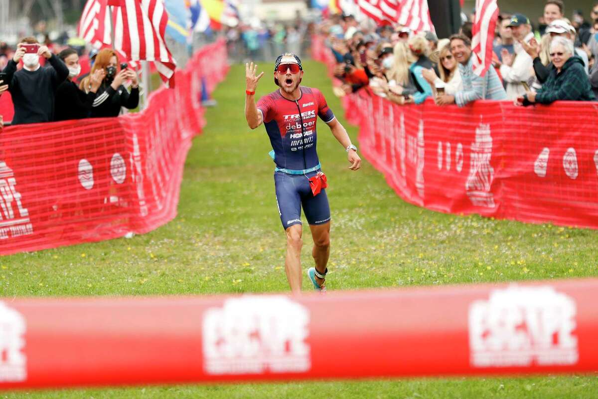 Ben Kanute starts to celebrate his fourth straight win of the Escape from Alcatraz Triathlon as he approaches the finish line.