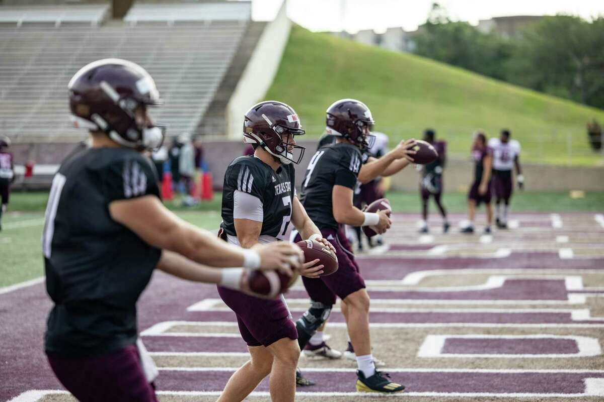 Texas State Quarterbacks Tyler Vitt (11), left, Brady McBride (2), center, and Ty Evans (4), right, warm up for an inter-squad scrimmage on Saturday, August 14, 2021, in San Marcos, TX. (Jordan Vonderhaar/Contributor)