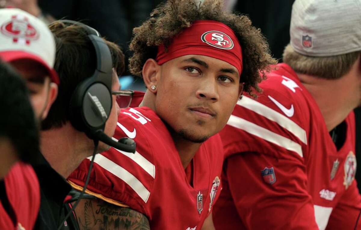 Trey Lance (5) talks with quarterbacks coach Rich Scangarelo on the bench after getting sacked and the 49ers punted in the first half as the San Francisco 49ers played the Kansas City Chiefs at Levi’s Stadium in Santa Clara, Calif., on Saturday, August 14, 2021.