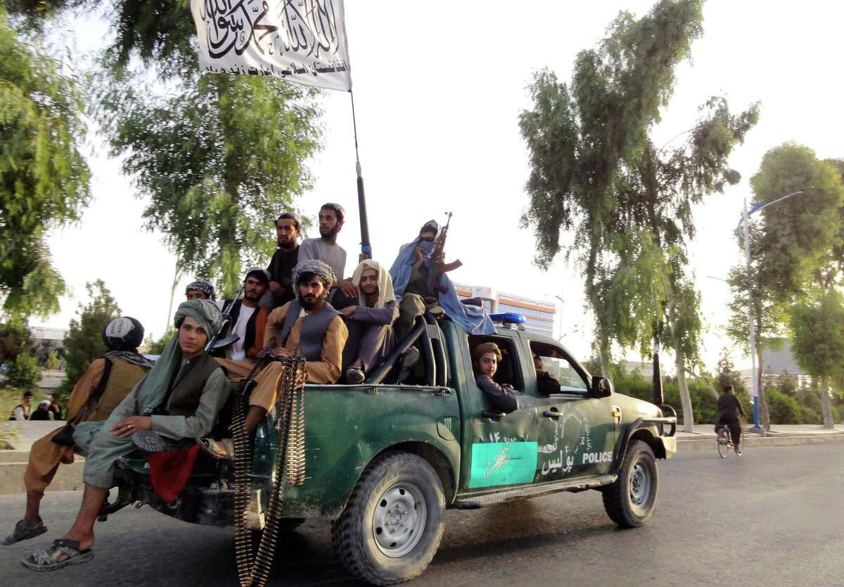 Taliban fighters patrol inside the city of Kandahar, southwest Afghanistan, on Sunday.