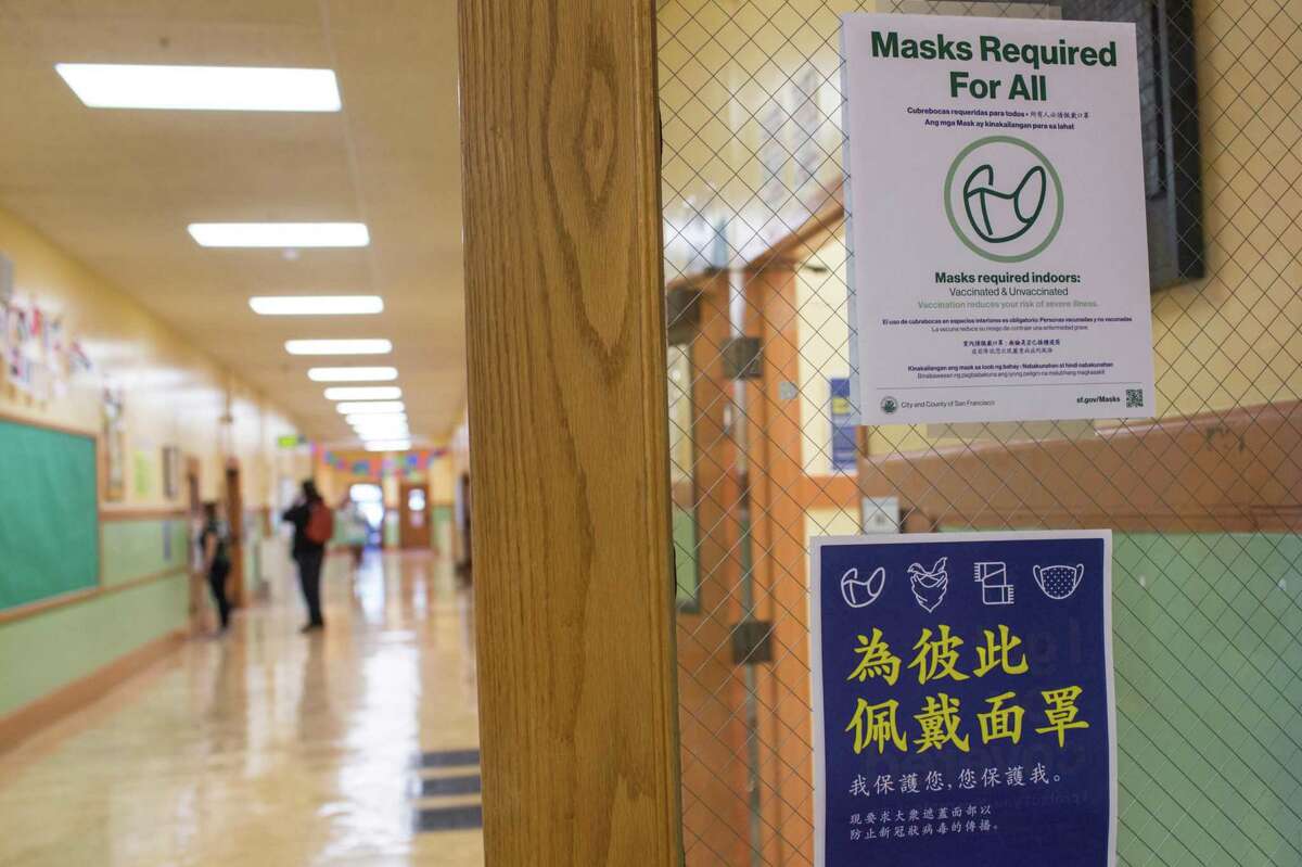 COVID safety signs are displayed in the hallways of Muir Elementary School in San Francisco as the district prepared to welcome its students and teachers back.
