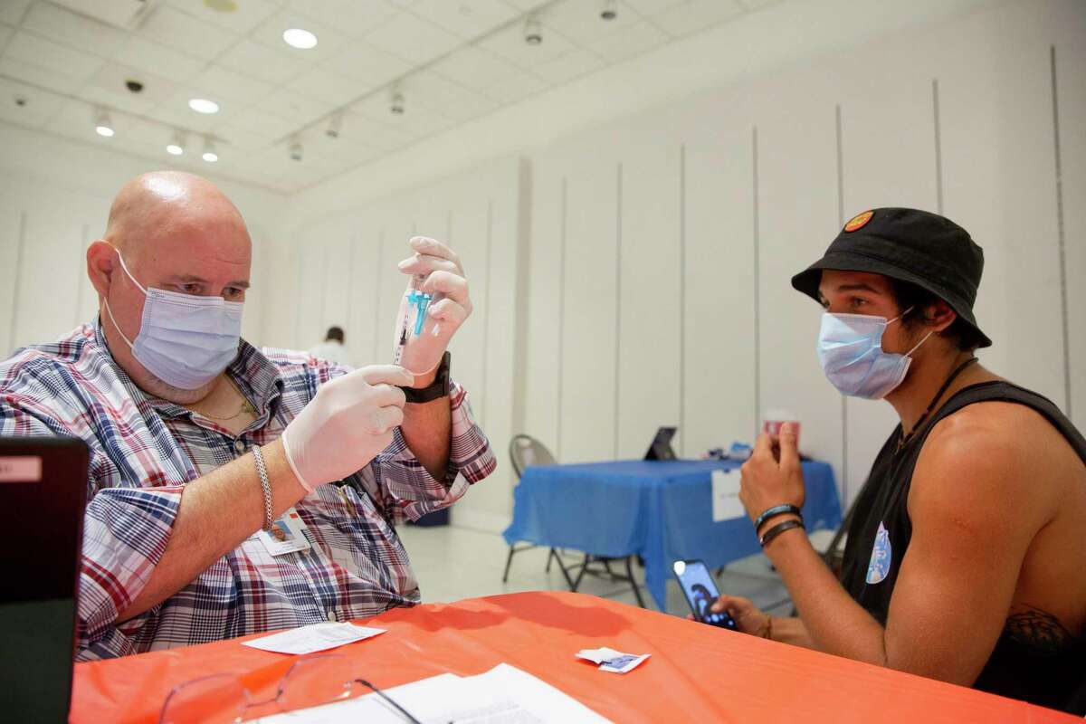 Michael Modrich, a Solano County Public Health nurse, prepares to administer a Johnson and Johnson Covid-19 vaccine to Franch Agustin in the Solano Town Center mall in Fairfield.