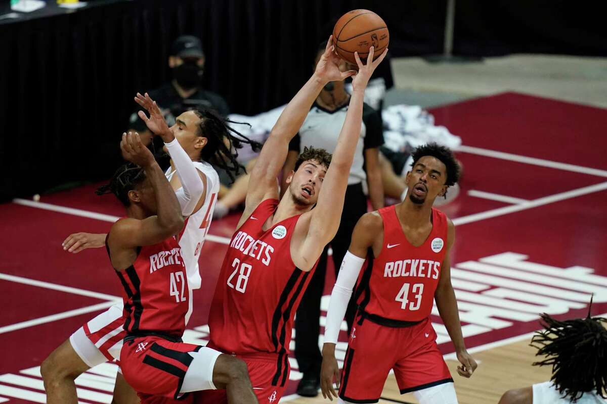 Houston Rockets' Alperen Sengun grabs a rebound against the Toronto Raptors during the second half of an NBA summer league basketball game Thursday, Aug. 12, 2021, in Las Vegas. (AP Photo/John Locher)