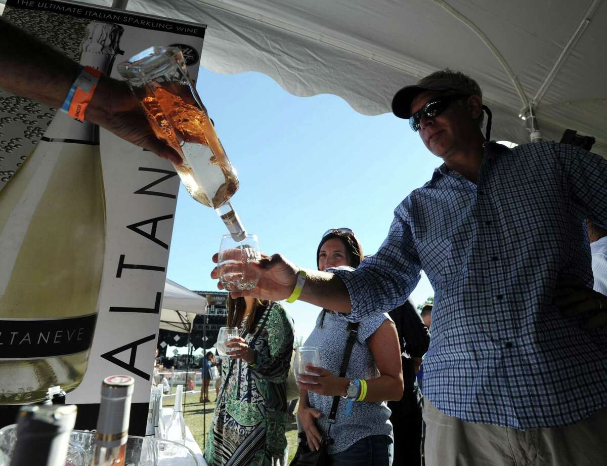 Arick Rynearson of Rowayton samples a glass of Altaneve wine during the Greenwich Wine & Food Festival at Roger Sherman Baldwin Park in Greenwich, Conn., Saturday, Sept. 24, 2016.