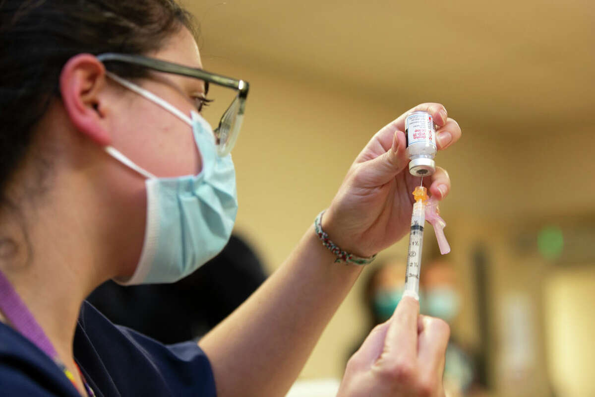SEATTLE, WA - DECEMBER 21: Colleen D Amico, a clinical pharmacist with Seattle Indian Health Board (SIHB) administers a shot of the Moderna COVID-19 vaccine, to frontline workers at the SIHB on December 21, 2020 in Seattle, Washington. The Seattle Indian Health Board (SIHB) received 500 doses of the FDA-approved Moderna COVID-19 vaccine today. (Photo by Karen Ducey/Getty Images).