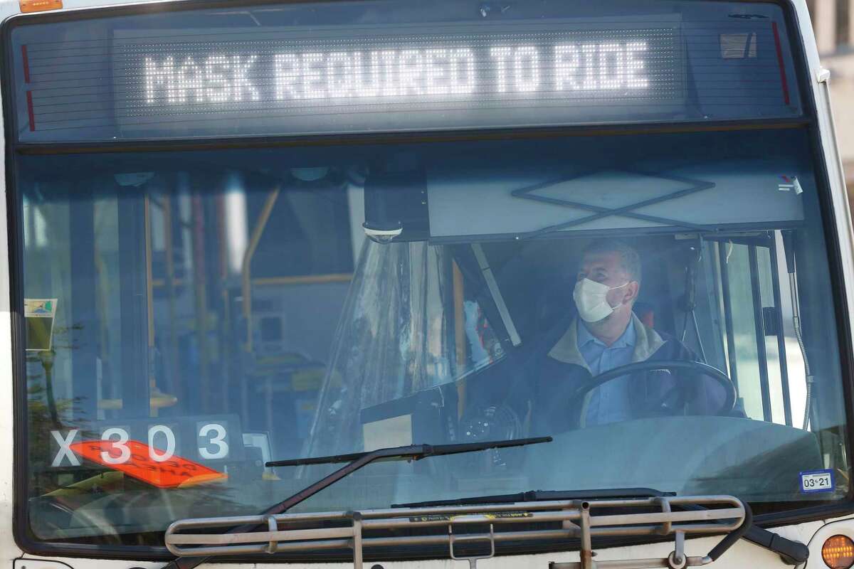 A Metropolitan Transit Authority bus operator waits for passengers at the Wheeler Transit Center on March 3, 2021, in Houston. Riders on all Metro buses and trains are required to wear masks.