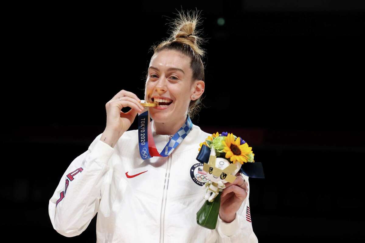 SAITAMA, JAPAN - AUGUST 08: Breanna Stewart #10 of Team United States bites her gold medal during the Women's Basketball medal ceremony on day sixteen of the 2020 Tokyo Olympic games at Saitama Super Arena on August 08, 2021 in Saitama, Japan. (Photo by Gregory Shamus/Getty Images)