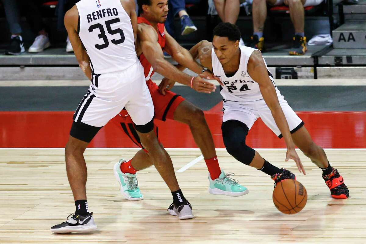 The Spurs’ Devin Vassell (24) drives the ball around the Chicago Bulls’ Jerome Robinson during the first half of an NBA summer league game in Las Vegas on Tuesday, Aug. 10, 2021.