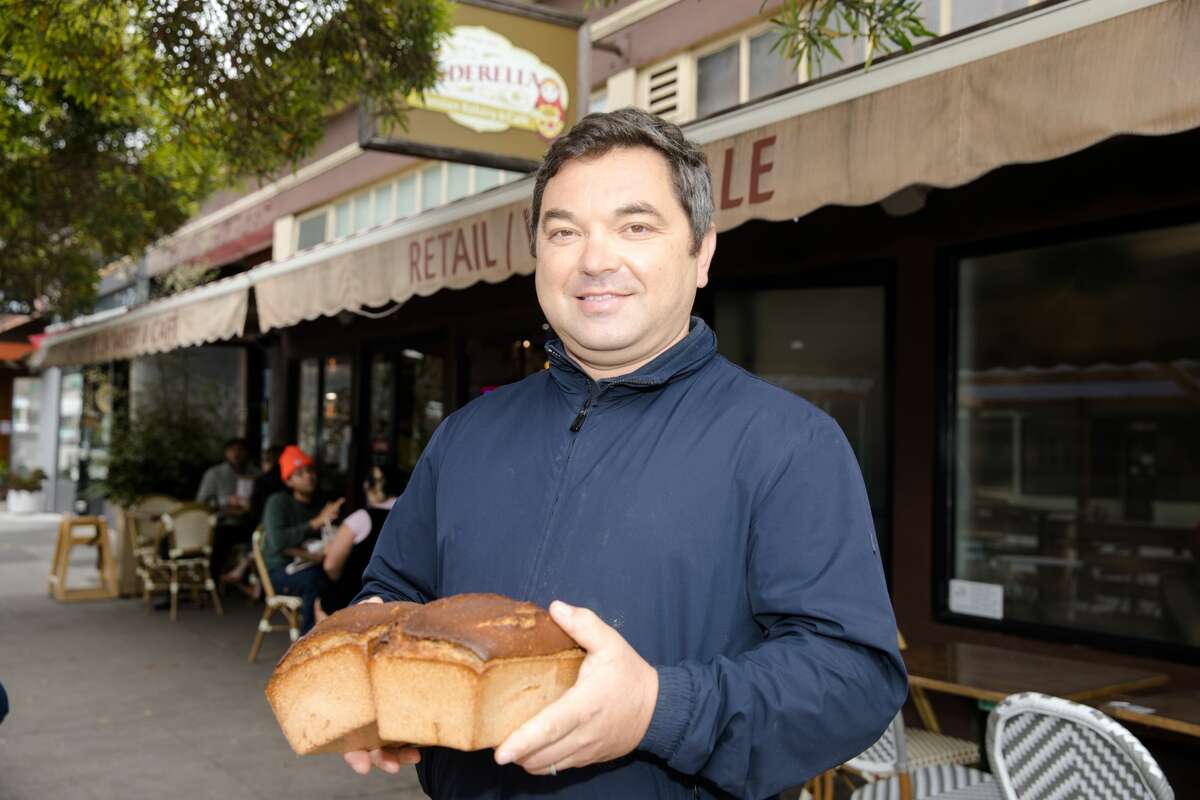 Cinderella Bakery and Cafe owner Mike Fishman holds two loaves of his bakery's signature rye bread outside his Russian bakery in the Richmond District of San Francisco, on Aug. 11, 2021.