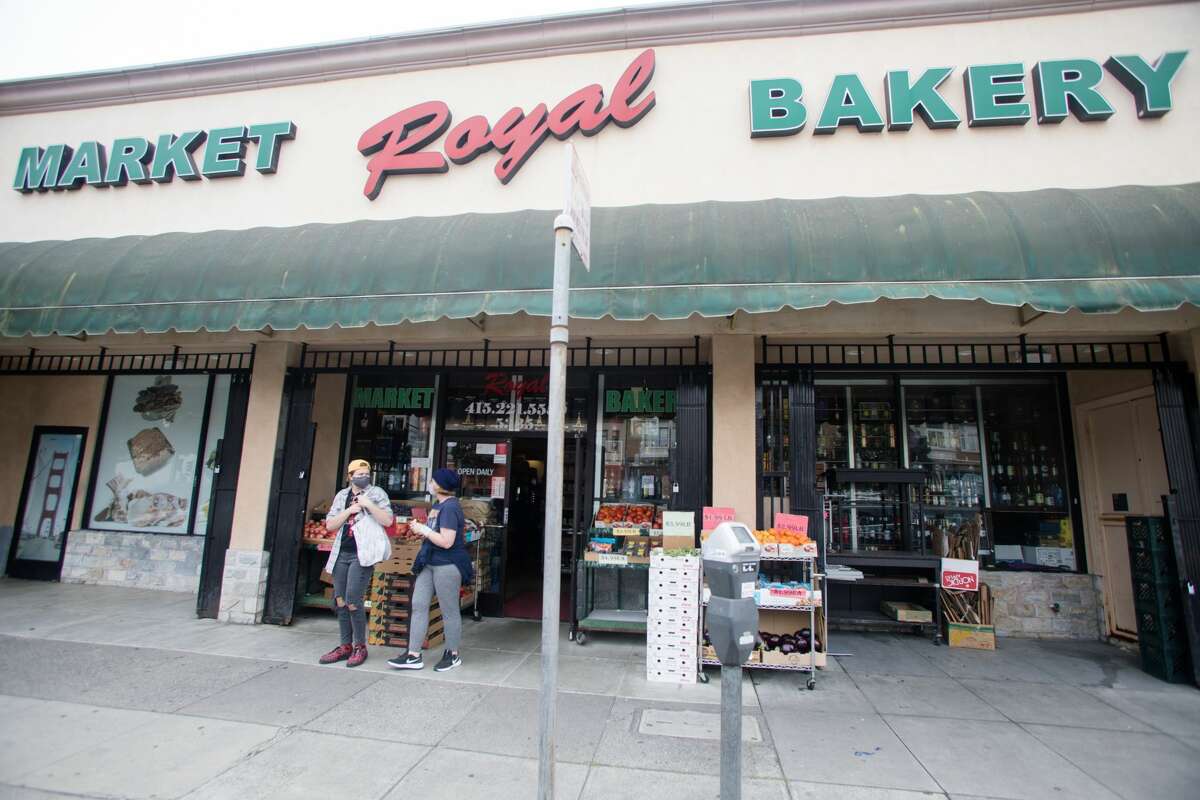 Two customers leave Royal Market Bakery, a Russian-Armenian grocery store in the Richmond District of San Francisco, on Aug. 11, 2021.