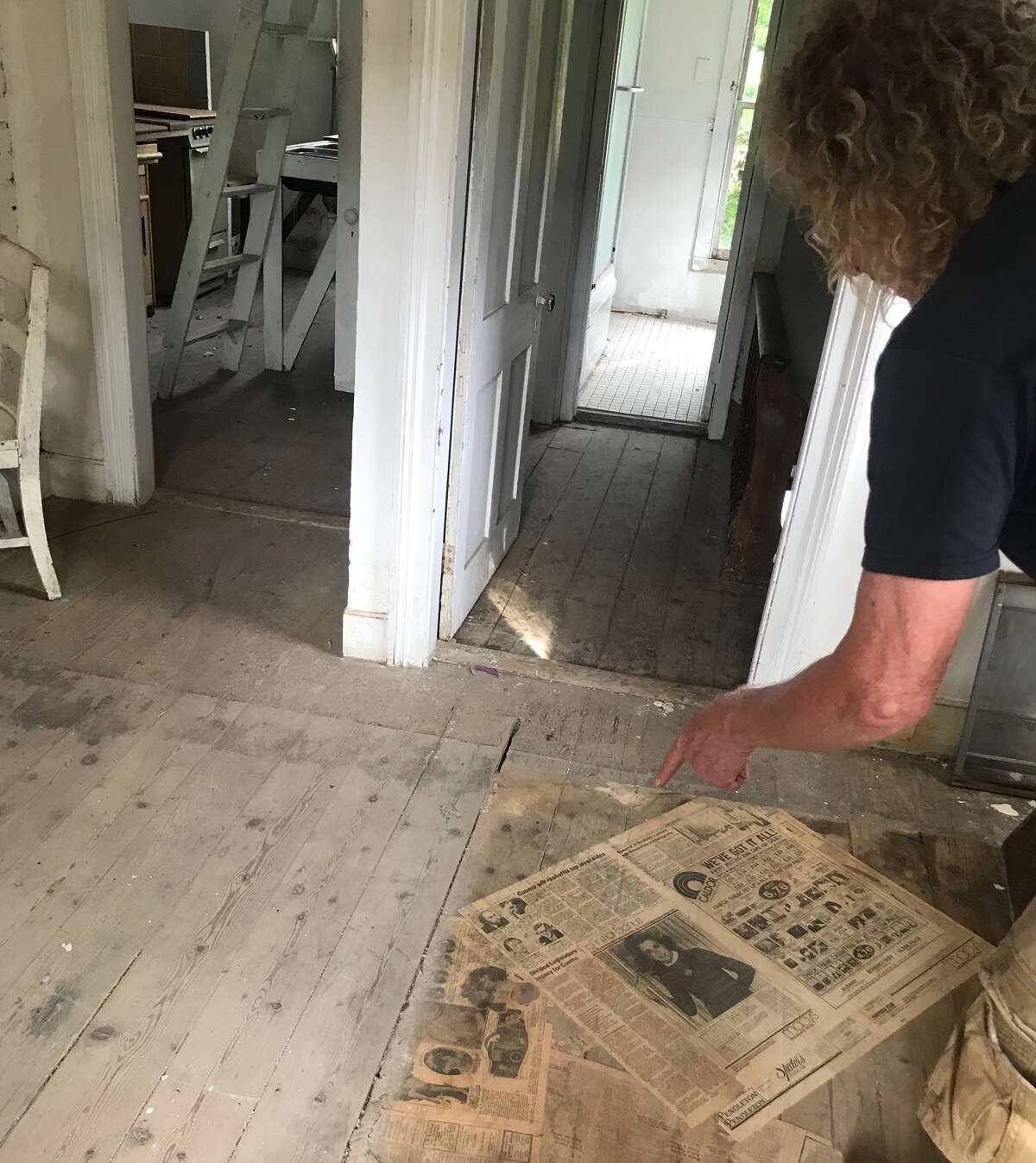 Inside Frank Cuthbert's new project in Athens, with some old newspapers including he had just found under a sheet of linoleum. 