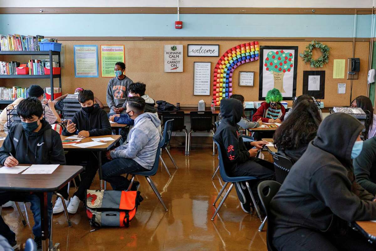 Students work in a classroom at Everett Middle School in San Francisco on the first day of in-person school for most students since March 16, 2020, due to the COVID pandemic.