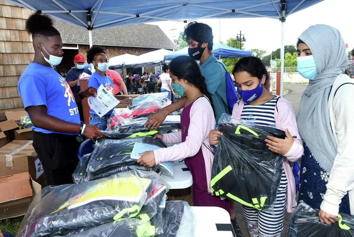 Children in the Khan family receive free backpacks at the New Haven Public Schools' Back To School Rally that also featured free school supplies at Bowen Field in New Haven on August 16, 2021.