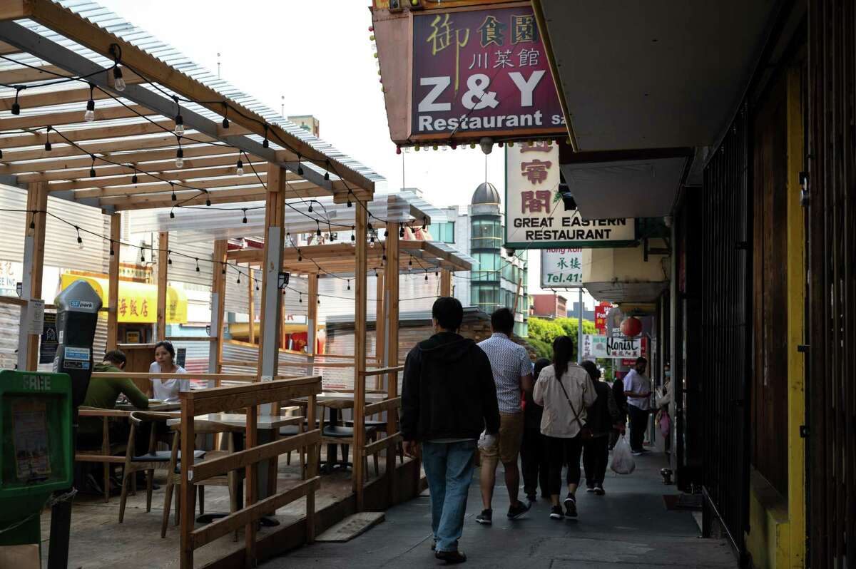 Pedistrians walk by noted Sichuan restaurant Z & Y in San Francisco's Chinatown. The restaurant has settled a $1.61 million wage theft case with 22 workers.