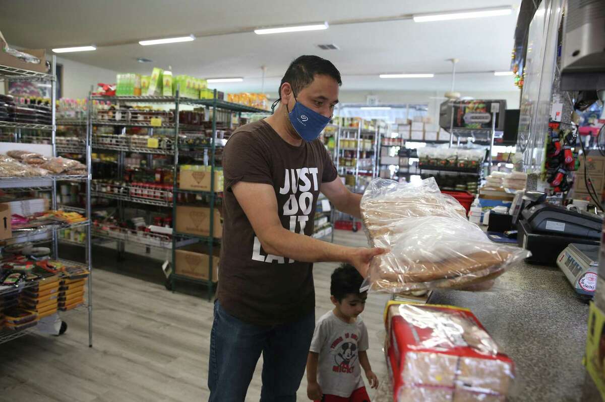 Safiullah Noorzad, of Fremont, shops for groceries at Maiwand with his son Mohammad Noorzad, 2, on Monday in Fremont. Noorzad is originally from Kabul and feels the situation has been getting worse everyday for his father, mother and soother family members who still live in Kabul.