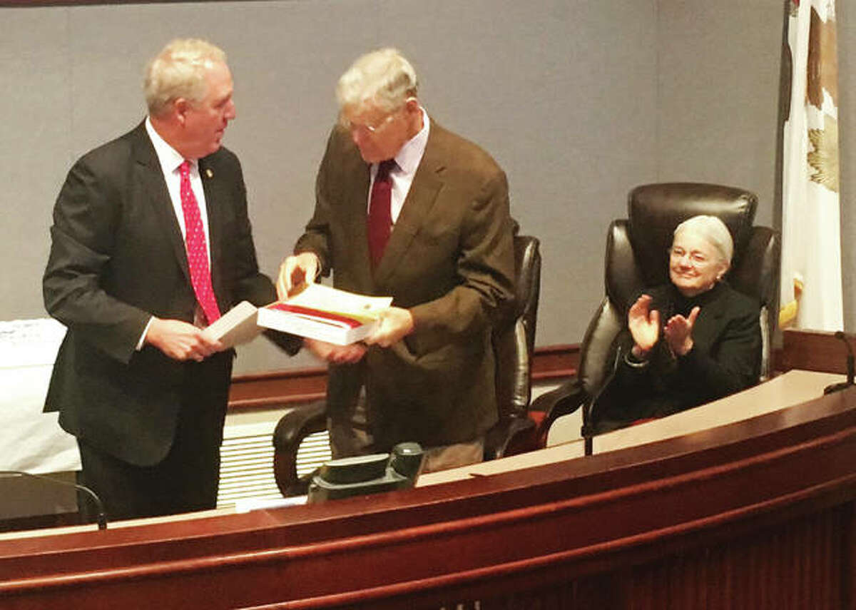 In November 2018, U.S. Rep. John Shimkus, R-Collinsville, left, presents retiring state Sen. William Haine, D-Alton, with a flag flown over the U.S. Capital for his retirement at the Madison County Administration buildings. Both elected officials started their elected careers in Madison County, Shimkus as treasurer and Haine as a county board member and later state’s attorney.