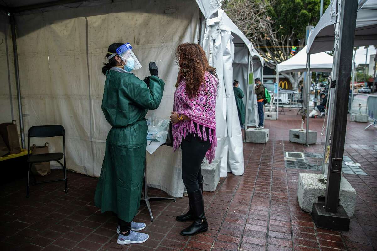 Venecia Margarita prepares to be swabbed on Valentine's Day at a rapid coronavirus testing site at the 24th Street Mission BART Plaza. S.F.'s new SoMa test site will bring the city's total capacity to about 5,000 per day.