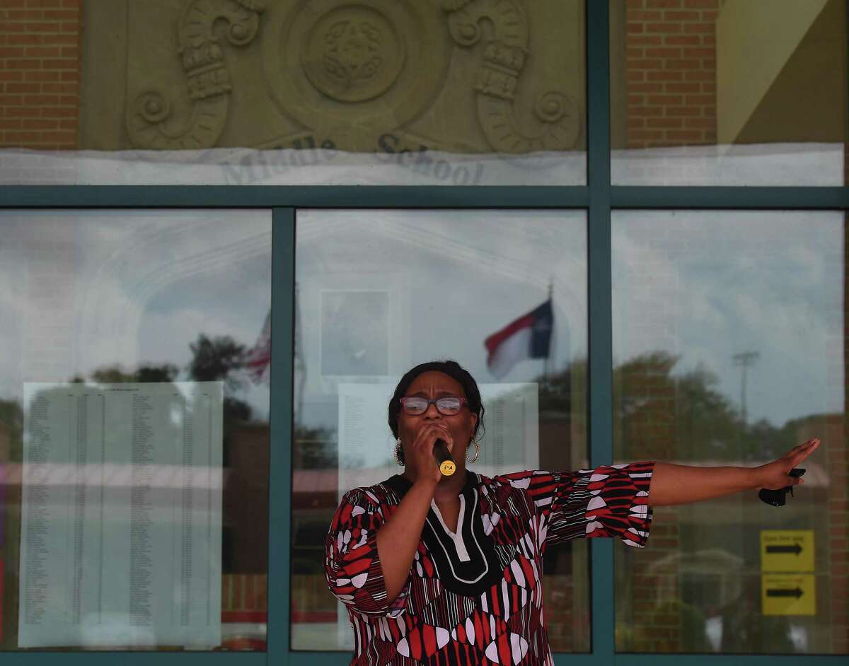 LaShonda Amerson sings as she joins in a prayer outside Martin Luther King, Jr., Middle School for a safe and successful school year before the start of the year Tuesday. It was amonng the 36 Beaumont schools that were covered in prayers as part of a community intitiative spearheaded by Angela Batiste. Photo made Monday, August 16, 2021 Kim Brent/The Enterprise