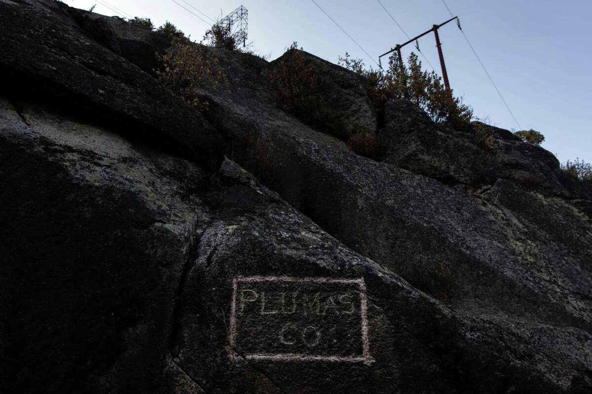 “Plumas Co.” is marked in chalk on burned rocks near Camp Creek Road in Plumas County last Saturday. Ignited on July 14, the Dixie Fire has been burning for over a month, and has grown to over 578,000 acres.