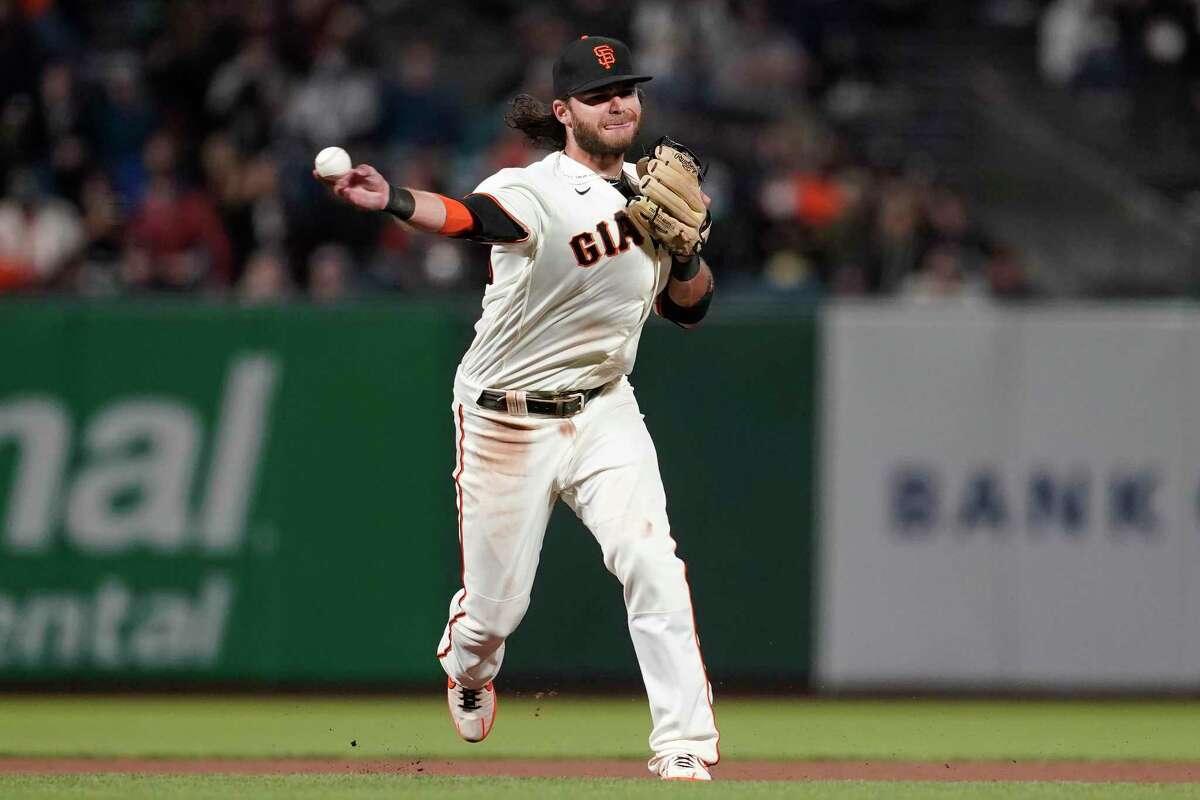 San Francisco Giants shortstop Brandon Crawford throws out New York Mets' Dominic Smith at first base during the seventh inning of a baseball game in San Francisco, Monday, Aug. 16, 2021. (AP Photo/Jeff Chiu)