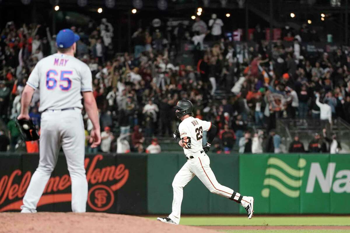 San Francisco Giants' Kris Bryant, right, rounds the bases after hitting a home run off of New York Mets pitcher Trevor May (65) during the seventh inning of a baseball game in San Francisco, Monday, Aug. 16, 2021. (AP Photo/Jeff Chiu)