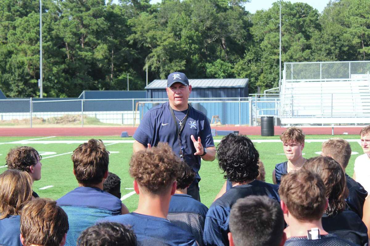 Kingwood coach Cale Melton talking with his Mustangs after the second day of fall camp in 2021 season.