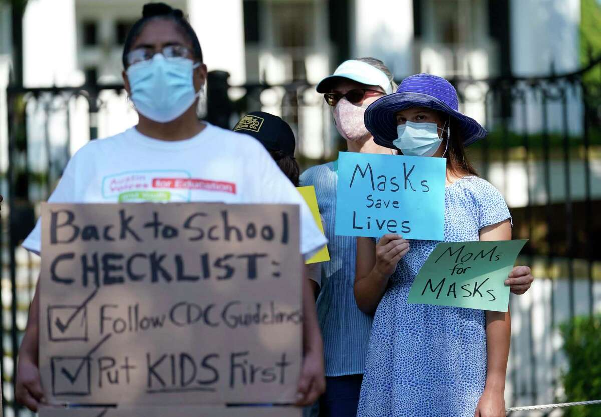 Students and parents gather outside the Governor's Mansion to urge Gov. Greg Abbott to drop his opposition to public school mask mandates, Monday, Aug. 16, 2021, in Austin, Texas. The Texas Supreme Court has blocked mask mandates ordered by two of the nation’s largest counties that defied Republican Gov. Greg Abbott as COVID-19 cases surge. (AP Photo/Eric Gay)