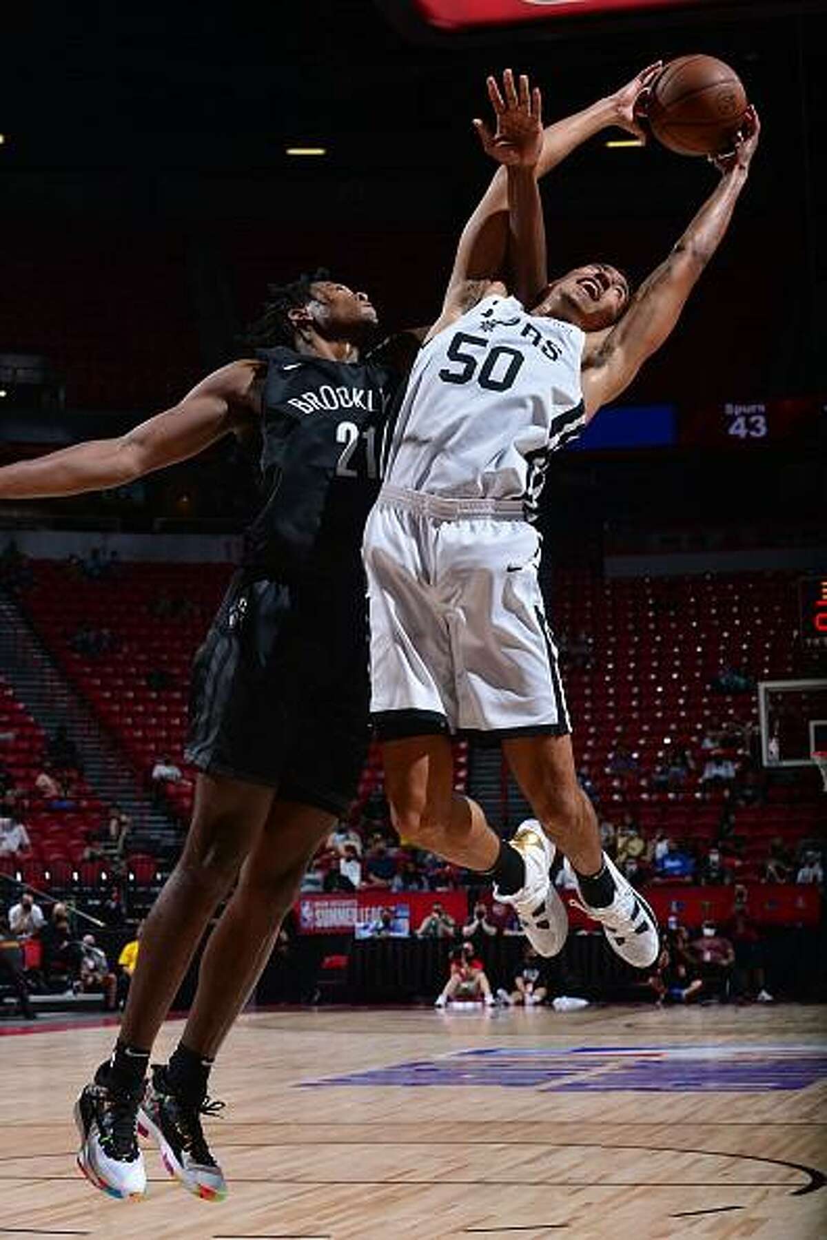 Justin Robinson #50 of the San Antonio Spurs rebounds the ball against the Brooklyn Nets during the 2021 Las Vegas Summer League on August 15, 2021 at the Thomas & Mack Center in Las Vegas, Nevada.
