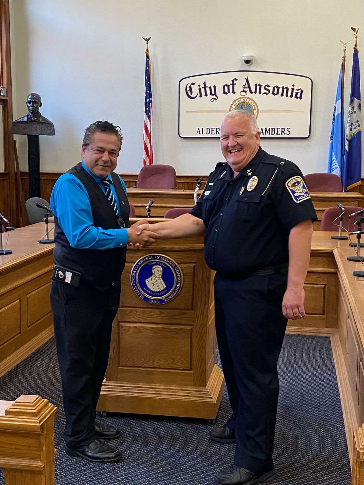 Mayor David Cassetti congratulates Lt. Wayne Williams after Williams was sworn in as the city’s interim police chief on Monday, Aug. 16 2021.