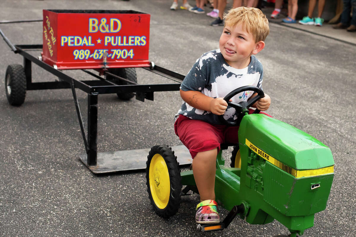 Sawyer Perry of Breckenridge, 4, pedals away on a miniature tractor during the children's pedal pull contest Tuesday, Aug. 17, 2021 at the Midland County Fair. (Katy Kildee/kkildee@mdn.net)