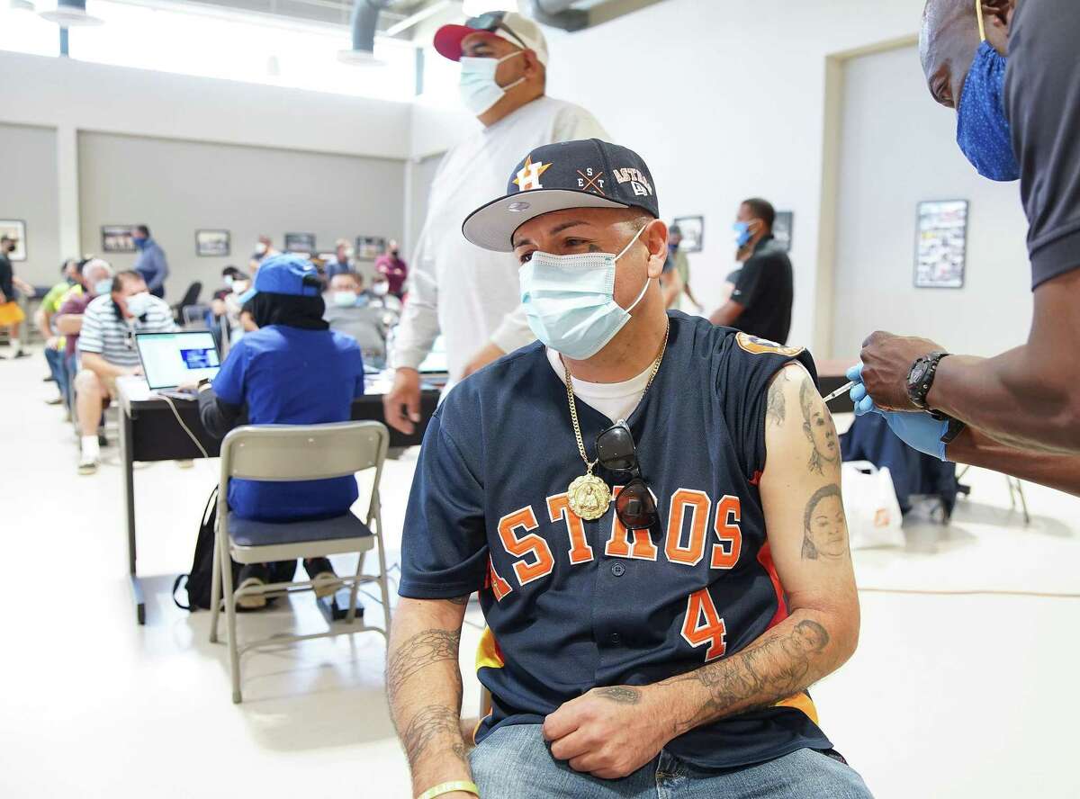 Tony Andrade, 43, of Houston gets his first shot of the Pfizer vaccine at the International Longshoresmen's Union Local 24 in Pasadena on Tuesday, March 23, 2021. The White House may soon be recommending a third shot.