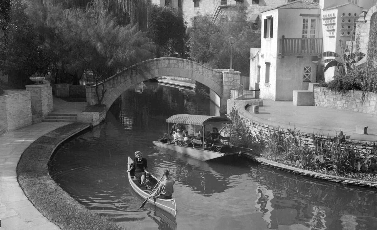 In this 1948 photo, a canoe shares the San Antonio River with a flat-bottomed boat in front of the Arneson River Theatre on the River Walk.